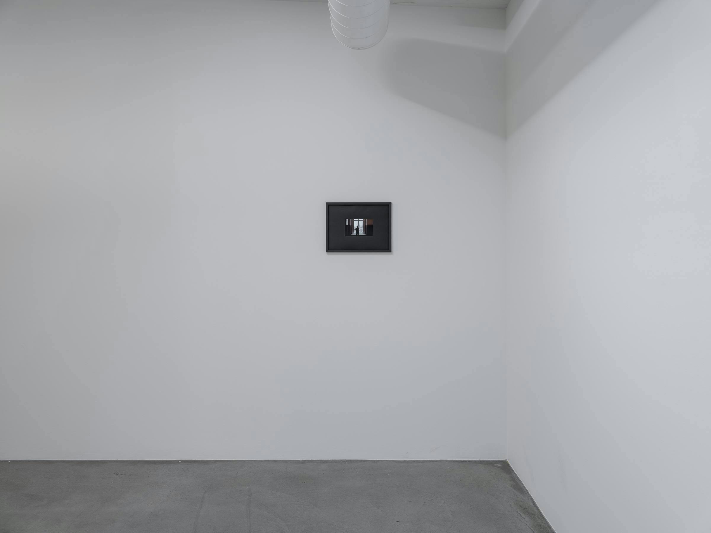 an image of a video artwork in a white gallery space with concrete floor