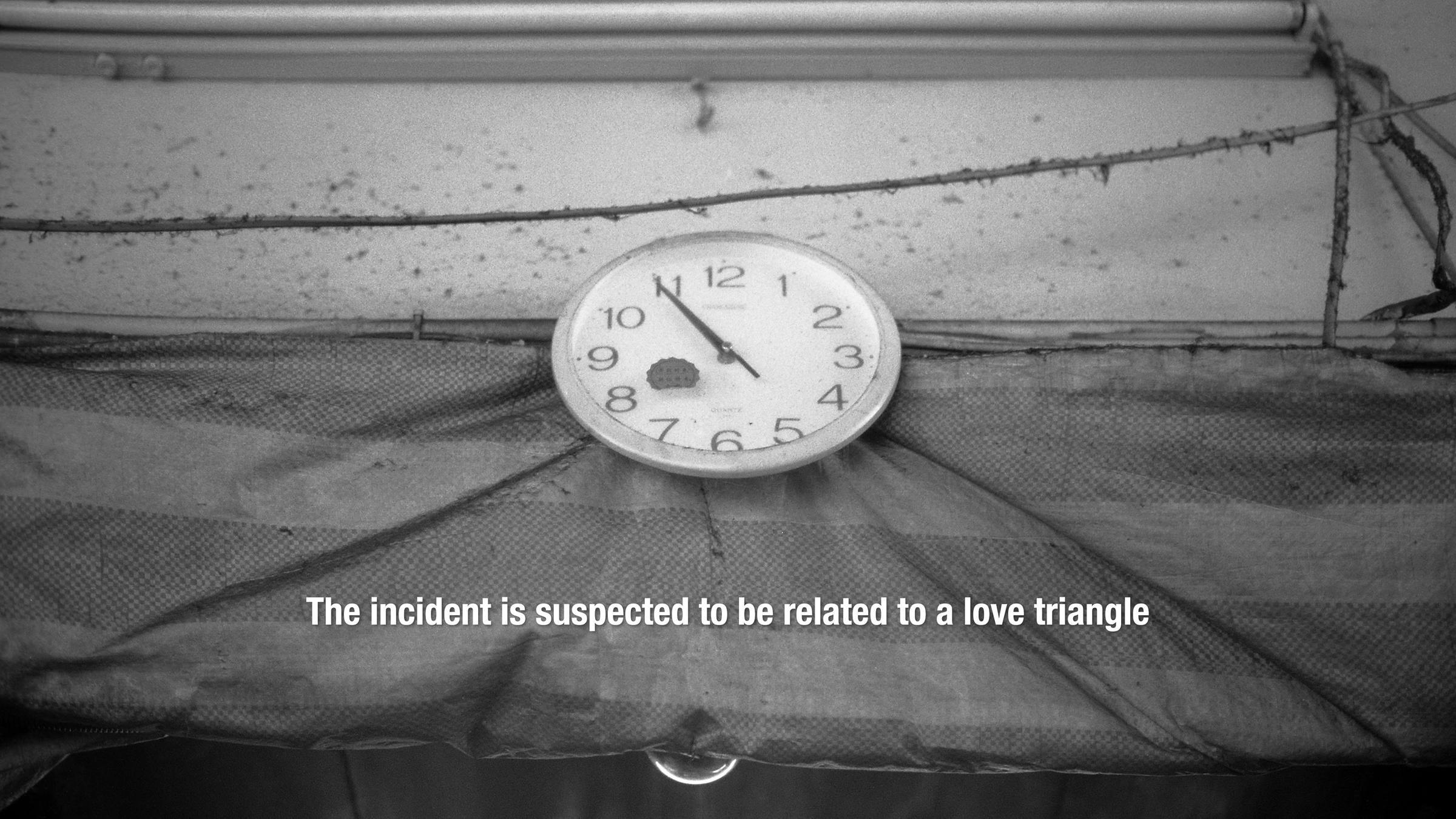 Black and white image of a clock fixed to a wall. The words 'The incident is suspected to be related to a love triangle' are superimposed on top.