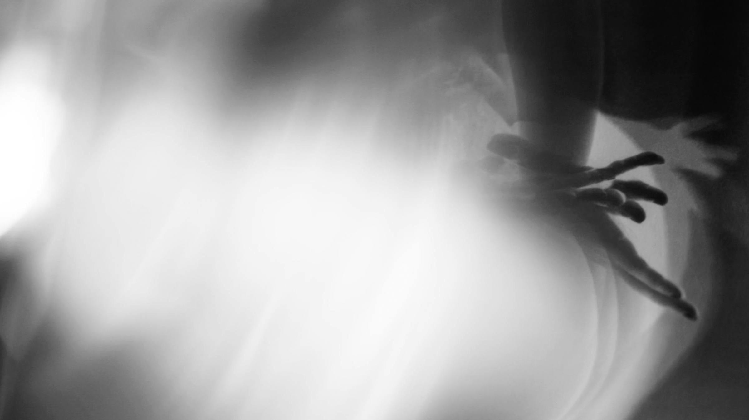 Black and white image with abstract forms and glowy white light.