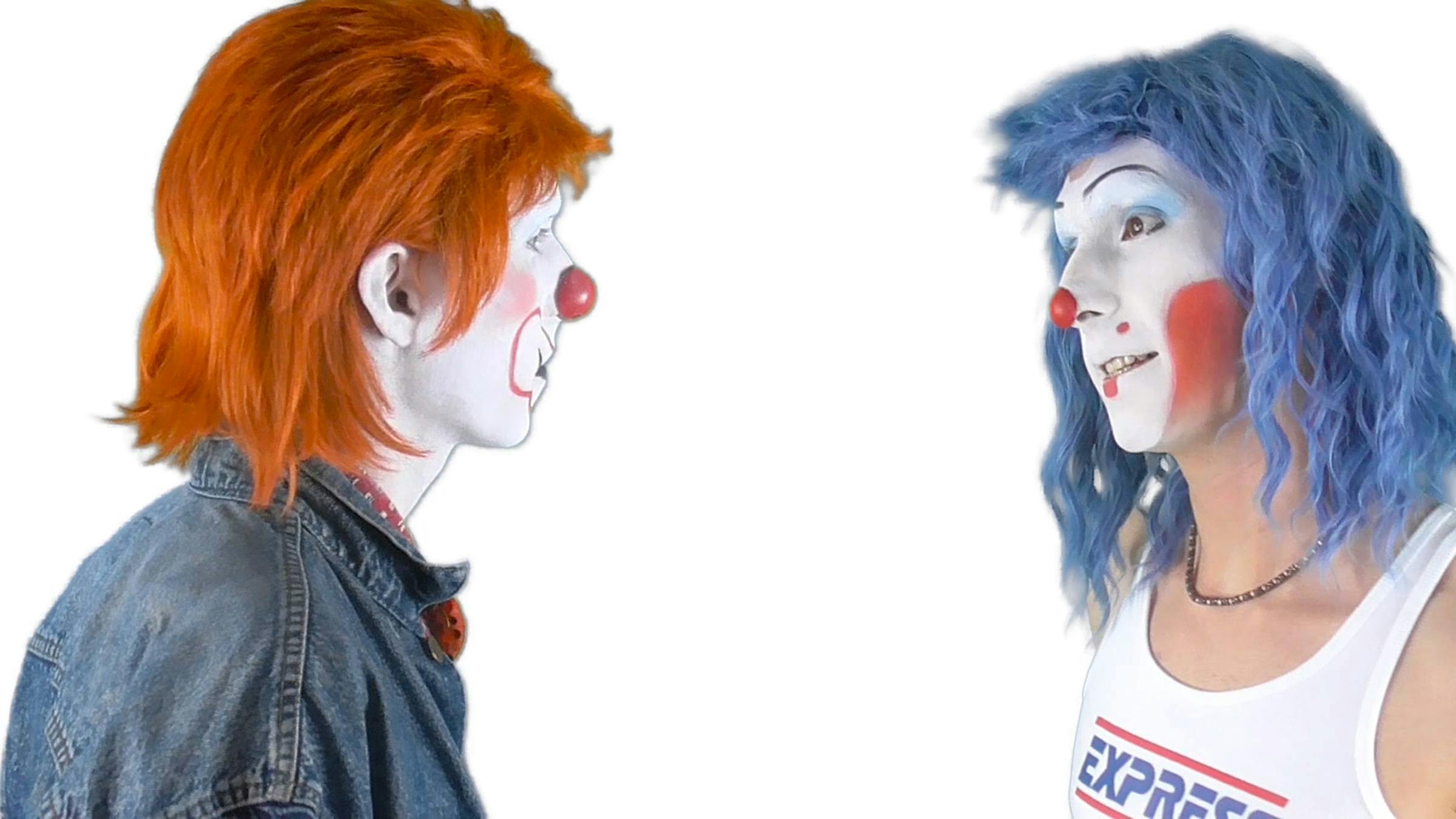 Two people wearing clown-like make up face each other as if they're having a conversation. One has orange hair and the other has blue hair.