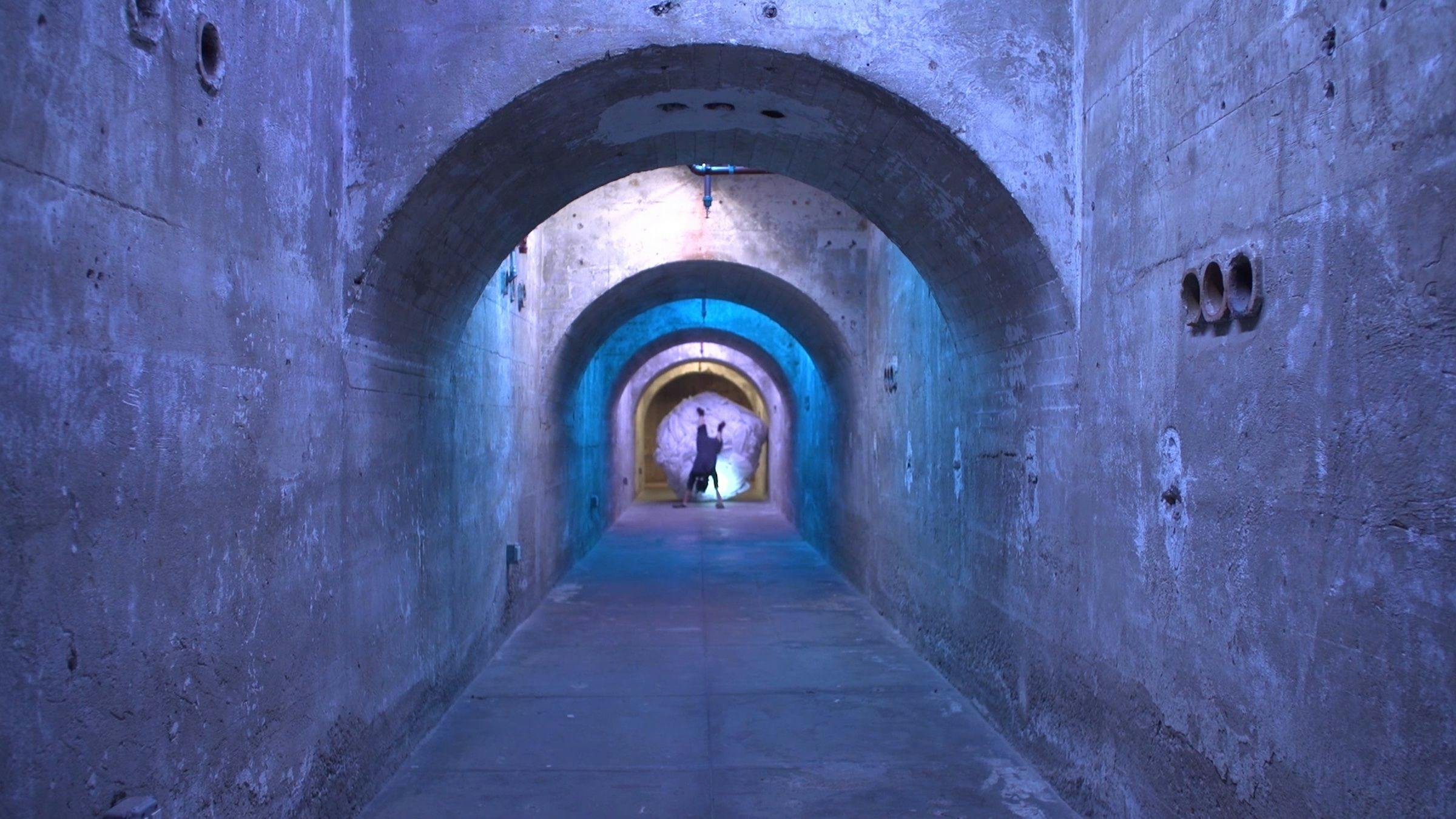 a tunnel that is lit with blue light