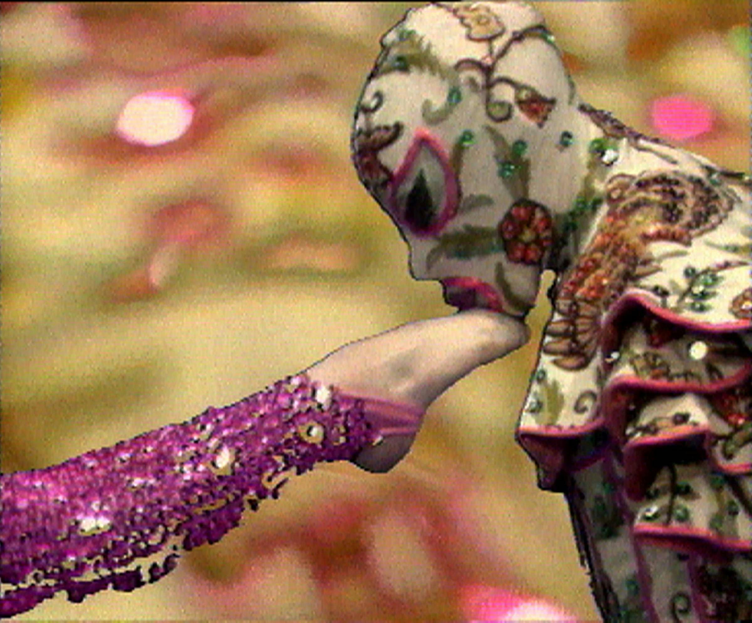 A leg wearing purple sparkly leggings is being kissed by a figure whose face and body and covered in an ornate multicoloured body suit