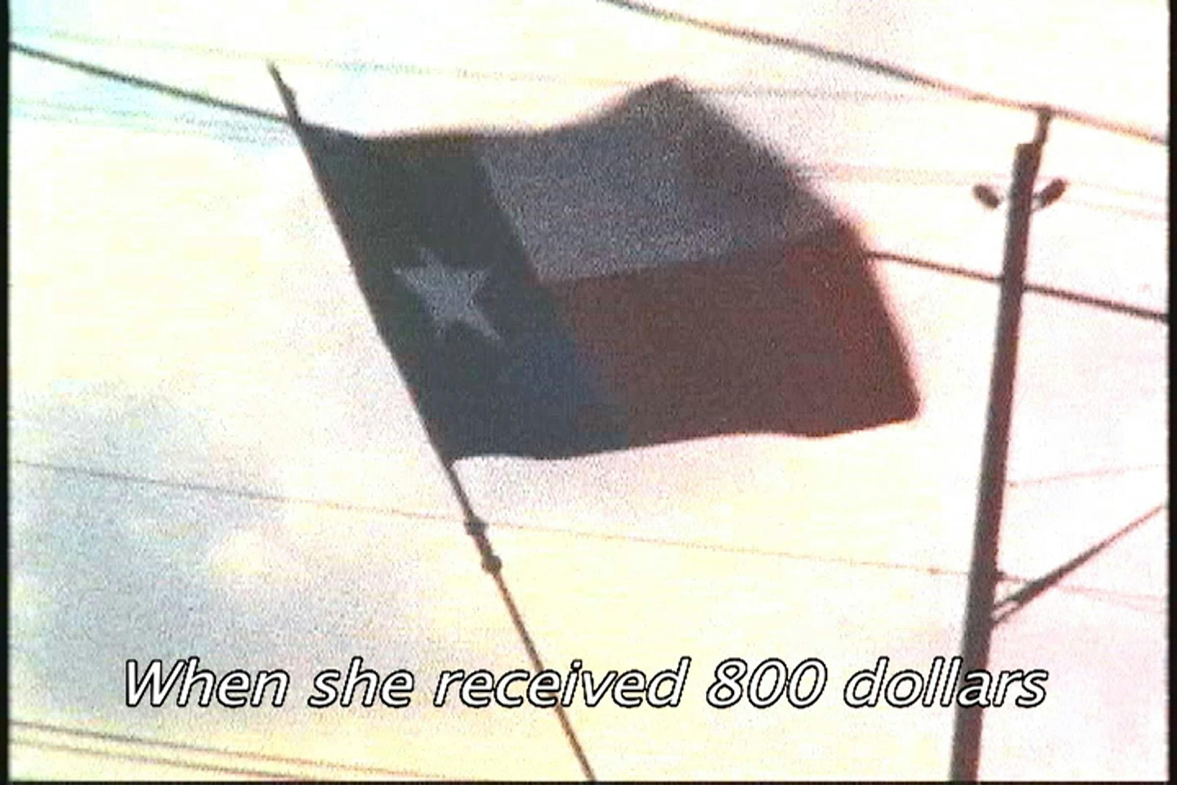 Image of Texas flag cast against a sunny and cloudy sky with telephone wires. The words 'When she received 800 dollars' are superimposed on top