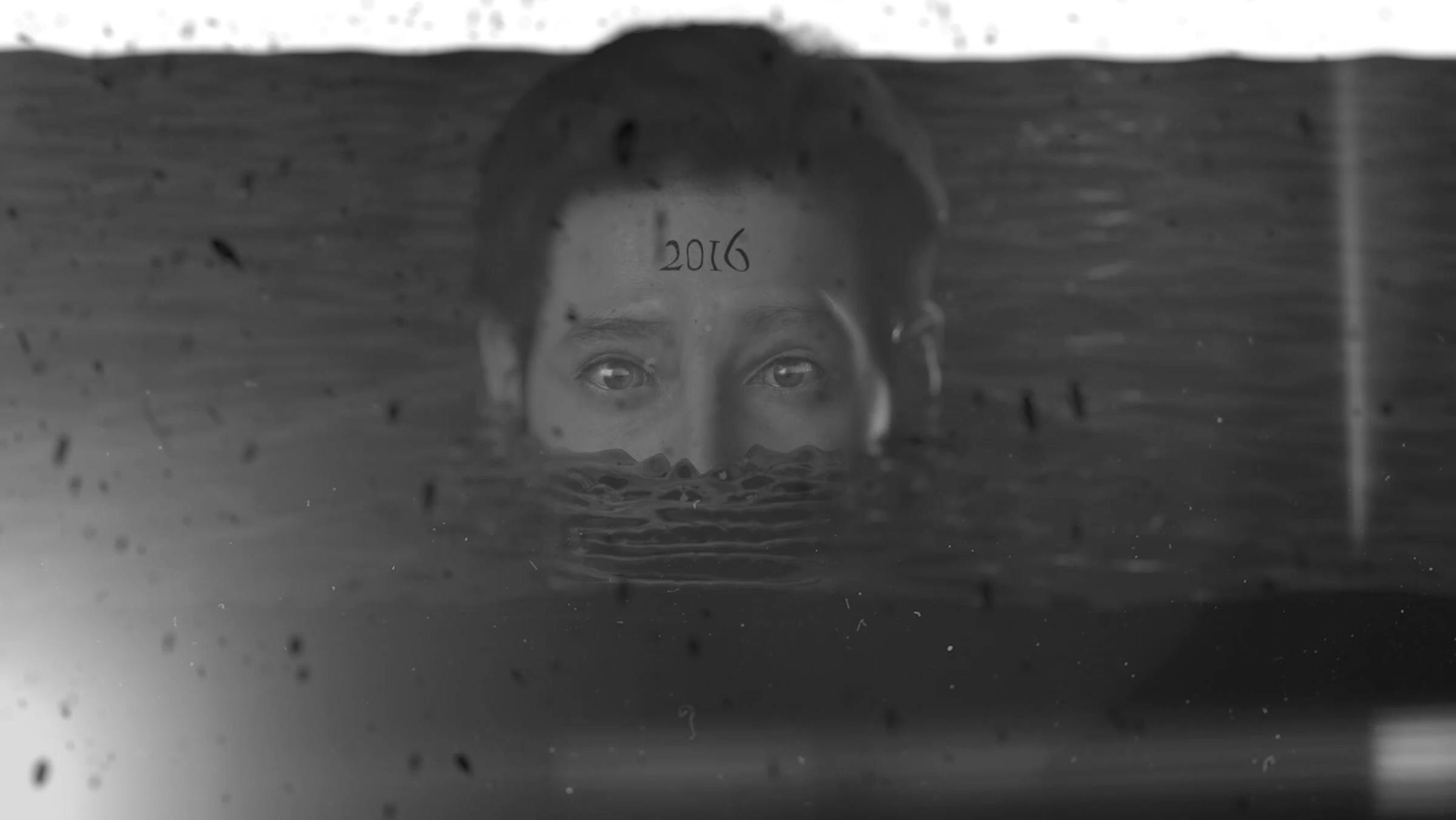 a digitally rendered face is visible above a water line from the nose up. The number 2016 are on their forehead