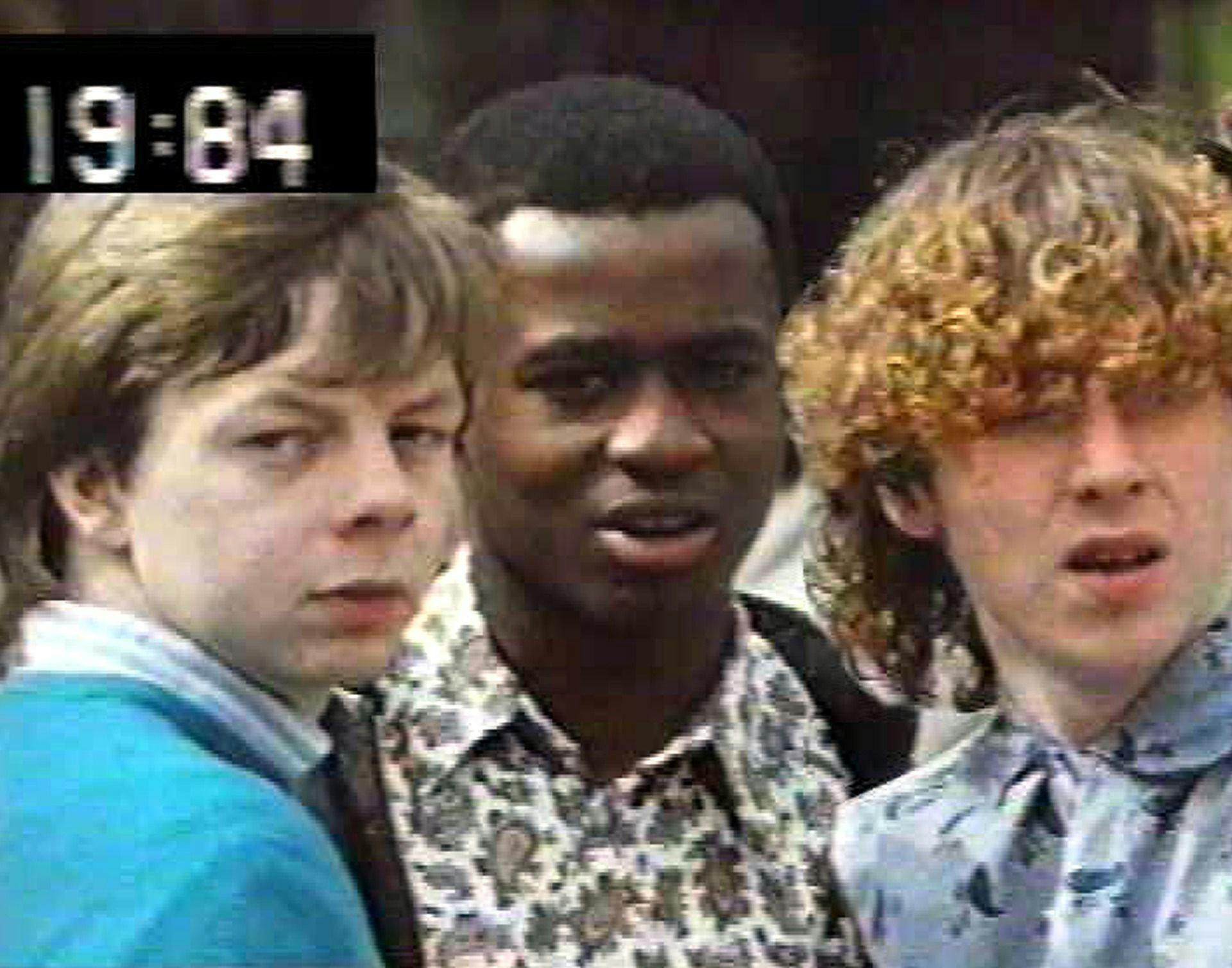 Image of three people from the shoulders up, two of them looking at the camera and the other looking into the distance. The numbers '19:84' appear in the top left corner as if it is VHS footage.