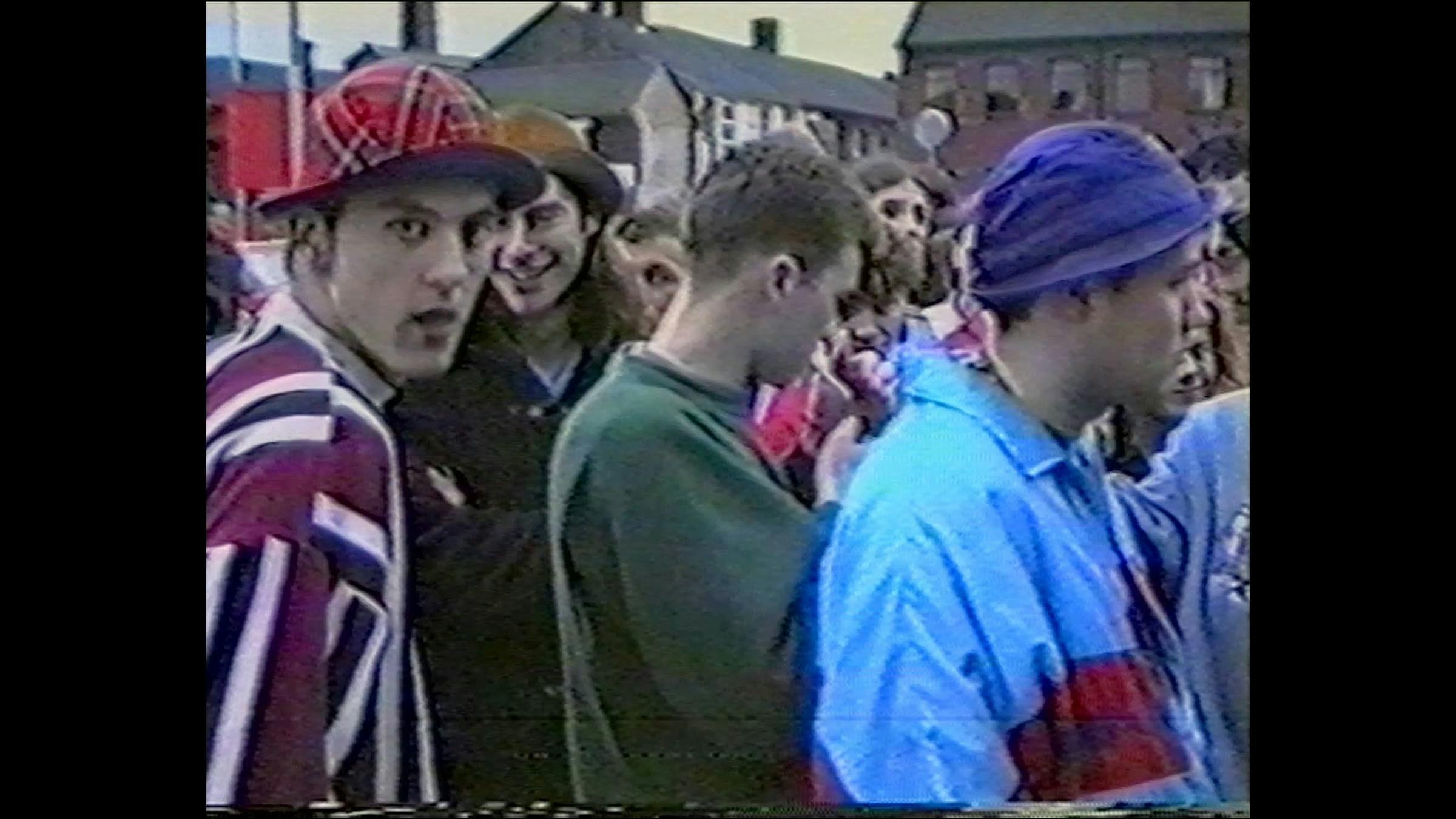 an image of young people in the 1990s at a rave in the street