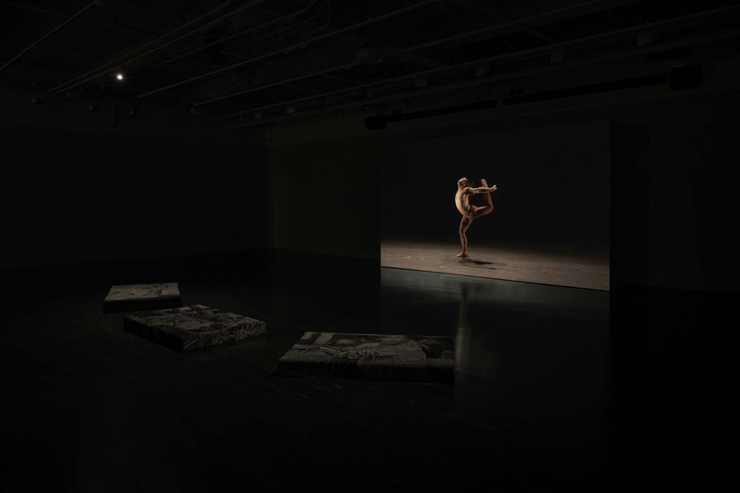 Installation view of The Heart of a Hand in a darkened space