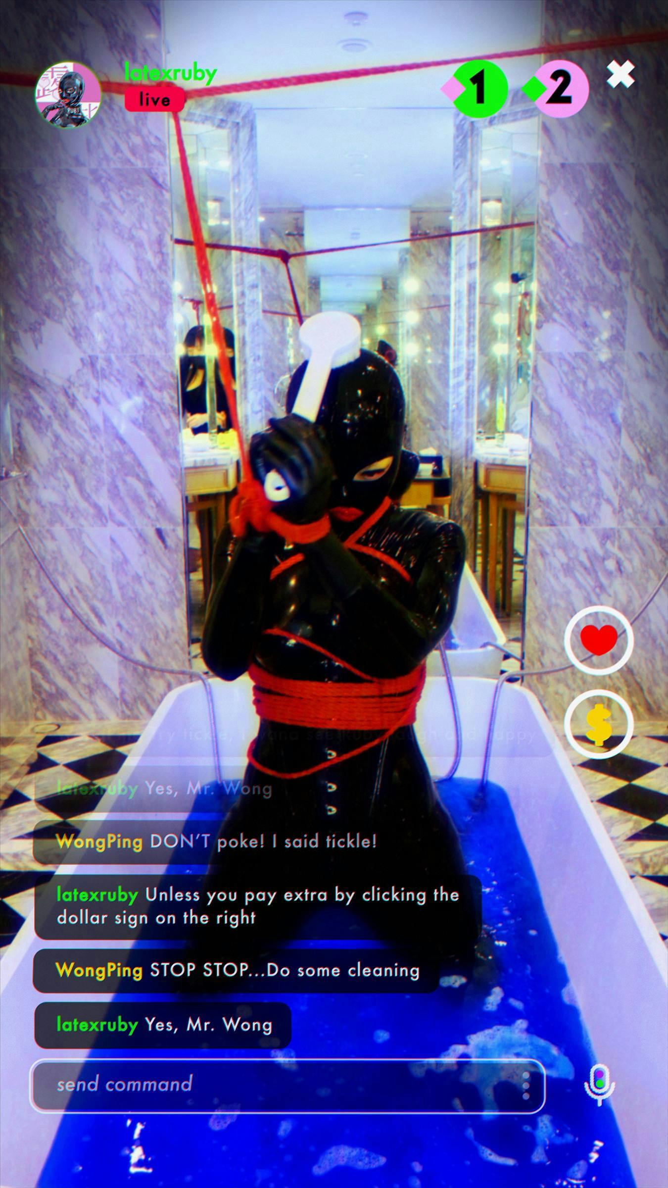 a figure wearing a black latex bondage suit kneels in a bath tub of blue liquid. A 'live' chat is  taking place between Latex Ruby and the artist Wong Ping. It looks as though we are looking at the screen of someone's phone.